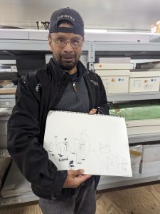 Person holding a drawing of glassware